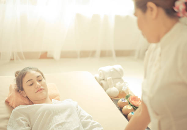 istock Woman lying on massage bed getting Thai Massage 868803126