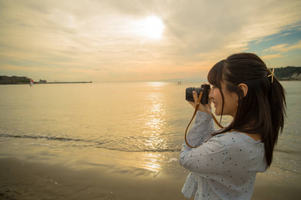 istock Two girls were playing on the beach, it was a beautiful sunset 868804780