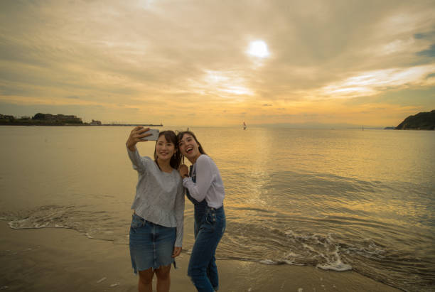 istock Two girls were playing on the beach, it was a beautiful sunset 868804832