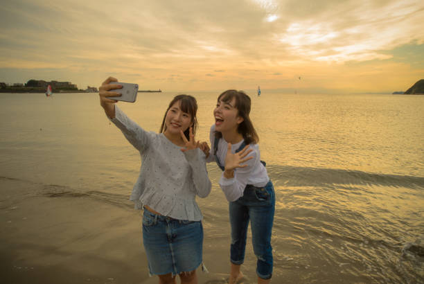 istock Two girls were playing on the beach, it was a beautiful sunset 868804854