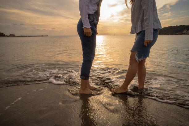 istock Two girls were playing on the beach, it was a beautiful sunset 868804866