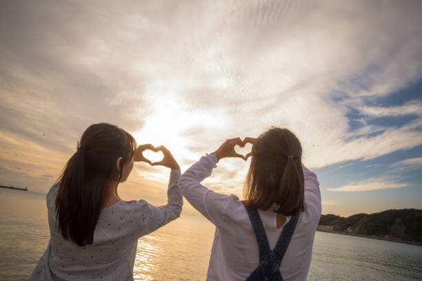 istock Two girls were playing on the beach, it was a beautiful sunset 868804890