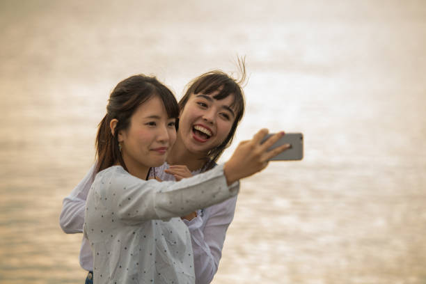 istock Two girls were playing on the beach, it was a beautiful sunset 868804986