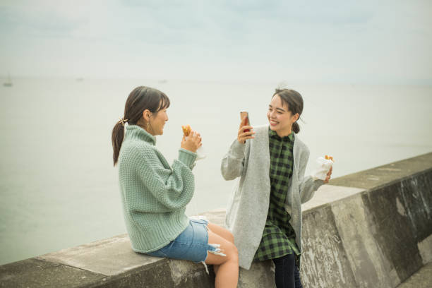 istock They take a sandwich lunch at the beachfront parking lot. . 868808374