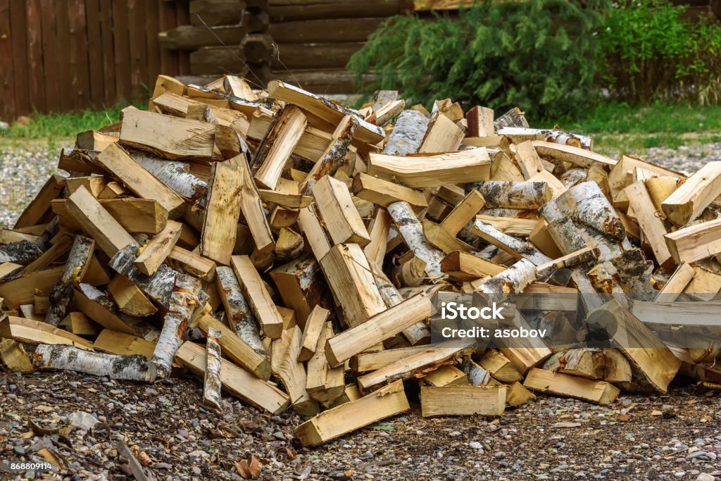 Pile of birch firewood outdoors in summer Firewood Stock Photo