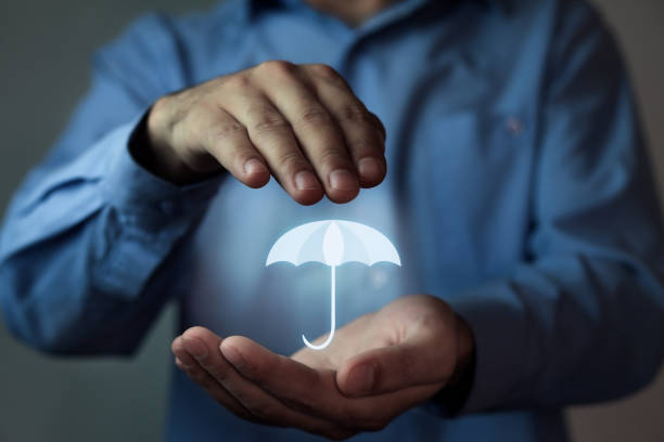 istock Man holding umbrella. Protection concept. 868811804