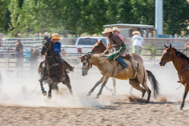 istock Cowboy Riding a Bucking Bronco at a Rodeo 868812352