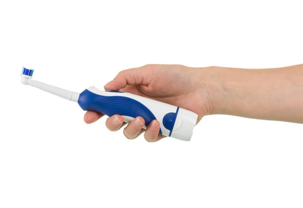 istock Electric toothbrush in hand isolated on white 868816154