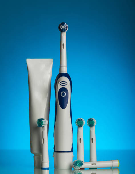 istock Electric toothbrush and replaceable nozzles to it on blue 868816164
