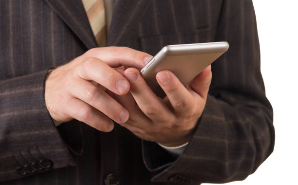 istock Business man in suit with smartphone isolated on white 868816210