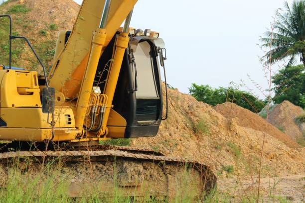 istock Heavy yellow excavators moving to the parking. 868822362