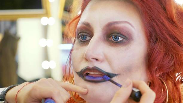 istock Process applying halloween makeup on face the woman in nurse style 868823134