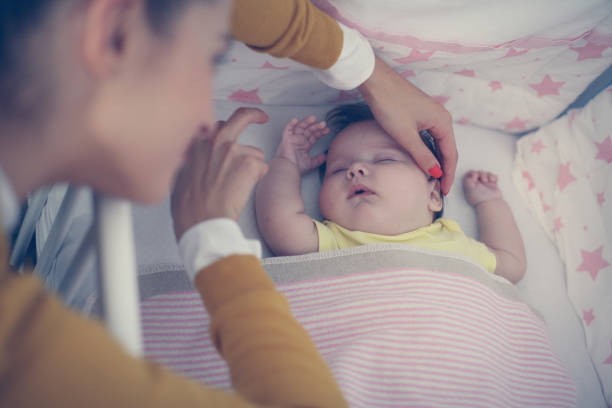 istock Cheerful young mother is sleeping  her baby. Close up. 868830256