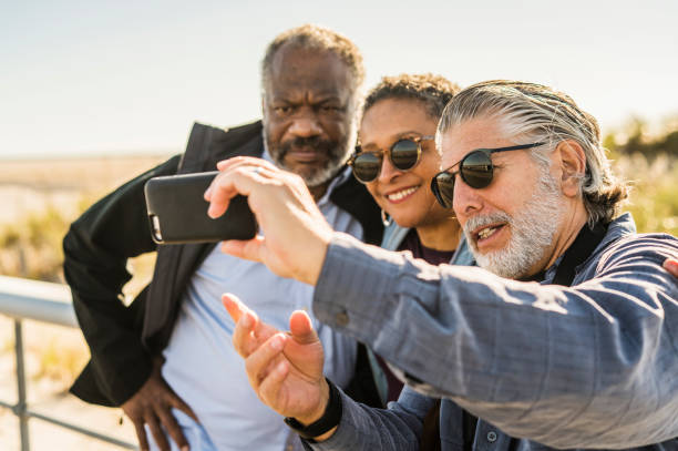 istock Senior friends take selfie at the beach 868830280