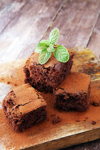 istock Cake chocolate brownies on wooden background with mint. 868833082