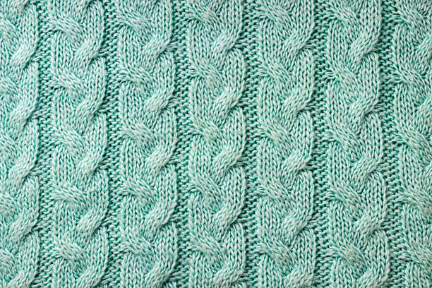 Knitted background. A sample of knitting from wool. Knitting Pattern.