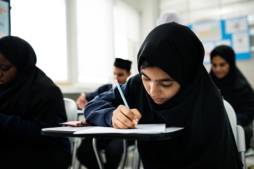 Muslim children studying in classroom