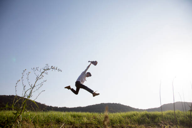 istock young powerful man jumping in field with guitar 868834940