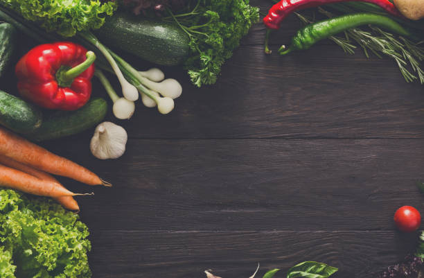 istock Border of fresh vegetables on wooden background with copy space 868841636