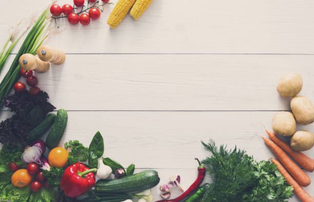 istock Fresh vegetables border on white wood background with copy space 868841830