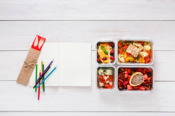 istock Healthy food, lunch in foil box on student table, diet 868841990