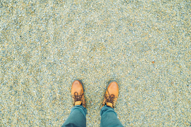 istock first person view on a boots on chippings 868848450