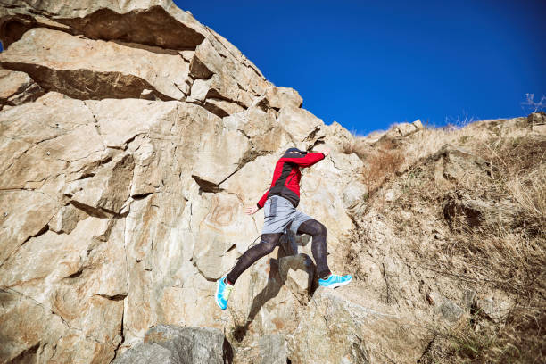 istock The guy is running on a difficult terrain in the mountains. 868849330