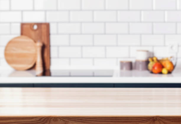 istock Wooden table in front of blurred modern kitchen. 868849368