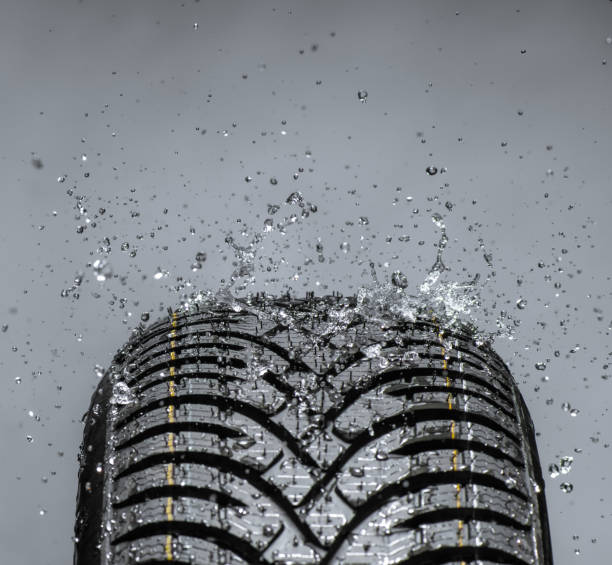 istock Water splashing on new tire 868849408