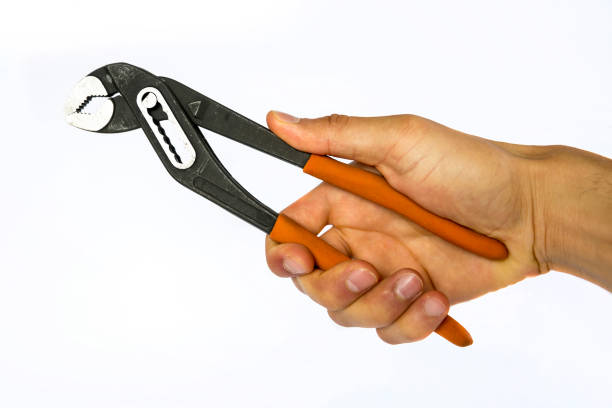 pince multiprise en main de l’homme - adjustable wrench wrench orange hand tool photos et images de collection