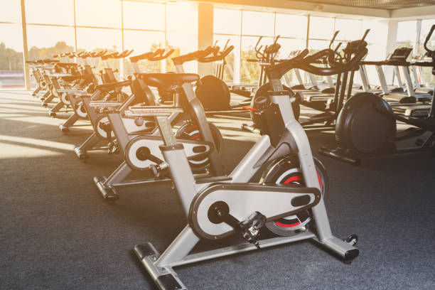 istock Modern gym interior with equipment, fitness exercise bikes 868849780