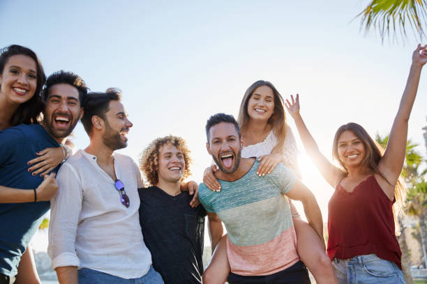 istock Group of young people laughing together outside 868853074