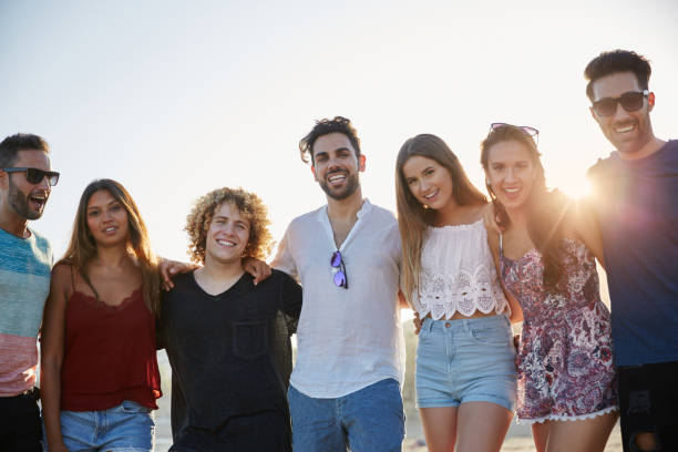 istock Group of happy friends standing together in sunlight 868854322