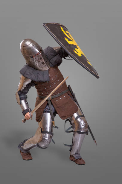 istock knight in breaths in a helmet with a sword and shield in battle over grey background 868854726