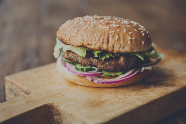 istock Classic american burger, fast food on wood background 868856588