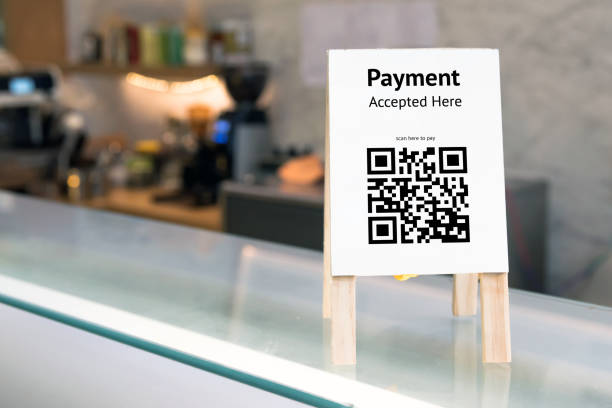 istock Qr code payment , online shopping , cashless society technology concept. Coffee shop accepted digital pay without money , wood stand tag on table. 868857644