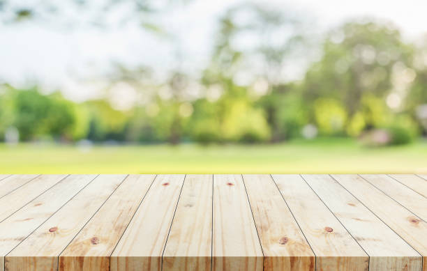 istock Wood table on blur green bokeh background used for display product 868864048