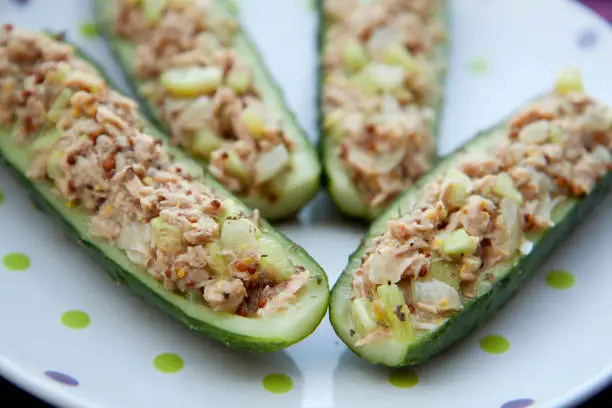 Healthy meal - four halves of tuna stuffed cucumbers on a plate.