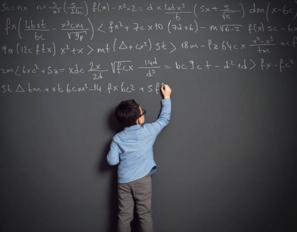 Little child in front of huge blackboard Cute child in front of huge blackboard. He knows answer. He writing formula. genius stock pictures, royalty-free photos & images