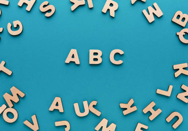 Alphabet made of wooden letters Back to school concept. Alphabet ABC made of wooden letters on blue background typescript print letterpress block stock pictures, royalty-free photos & images