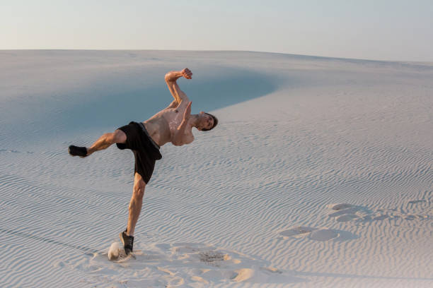 istock Man study parkour on their own. Acrobatics in the sand 868866712