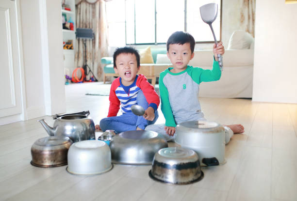 istock Two brother playing on floor with pots and pans 868866734