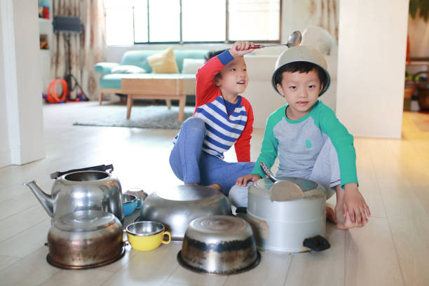 istock Two brother playing on floor with pots and pans 868866968