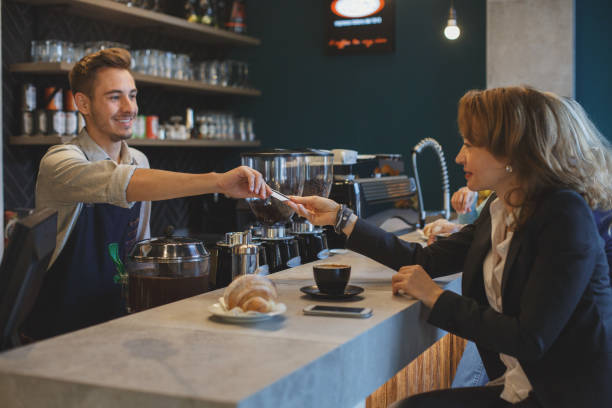 istock Woman paying for her breakfast 868867068