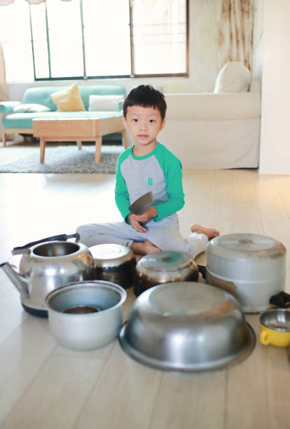 istock Child playing on floor with pots and pans 868871596
