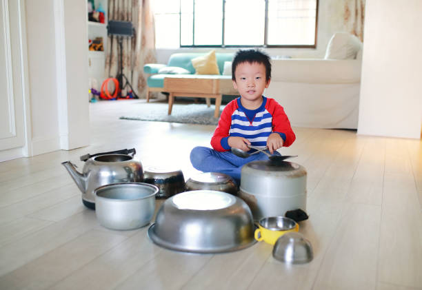 istock Child playing on floor with pots and pans 868871814
