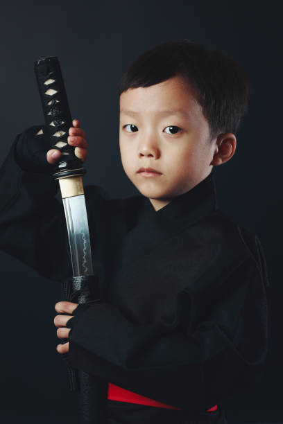 忍者の衣装を着た少年 - samurai katana chinese ethnicity men ストックフォトと画像