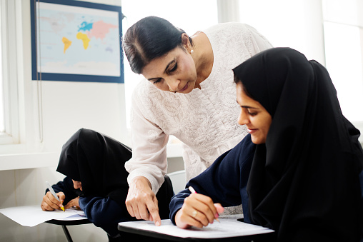 diverse muslim girls studying in classroom