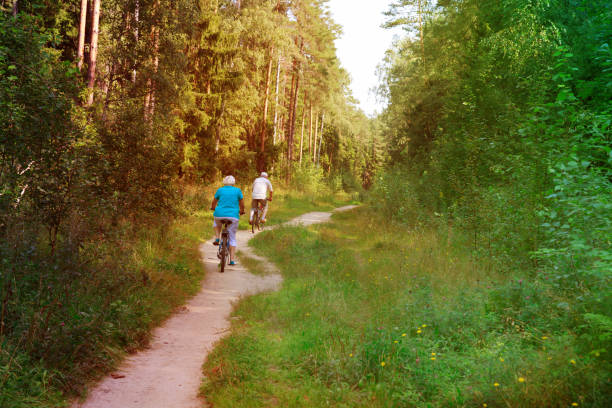 istock active senior couple riding bikes in nature 868872884