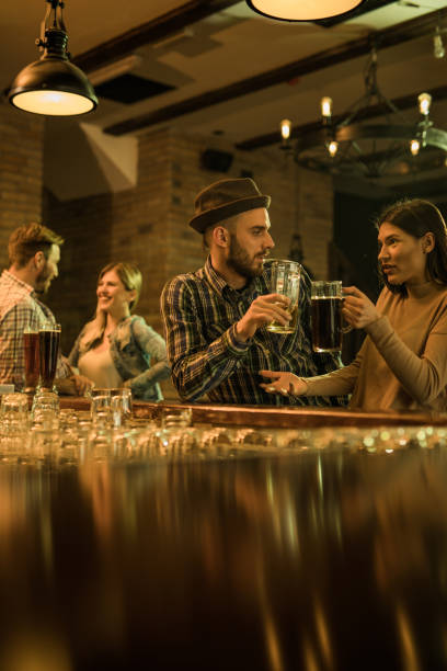 istock Young couples communicating during their night out in a pub. 868873020